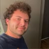 Casual selfie of man in blue shirt.